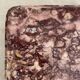 Pink marble trivet with brass ball feet.