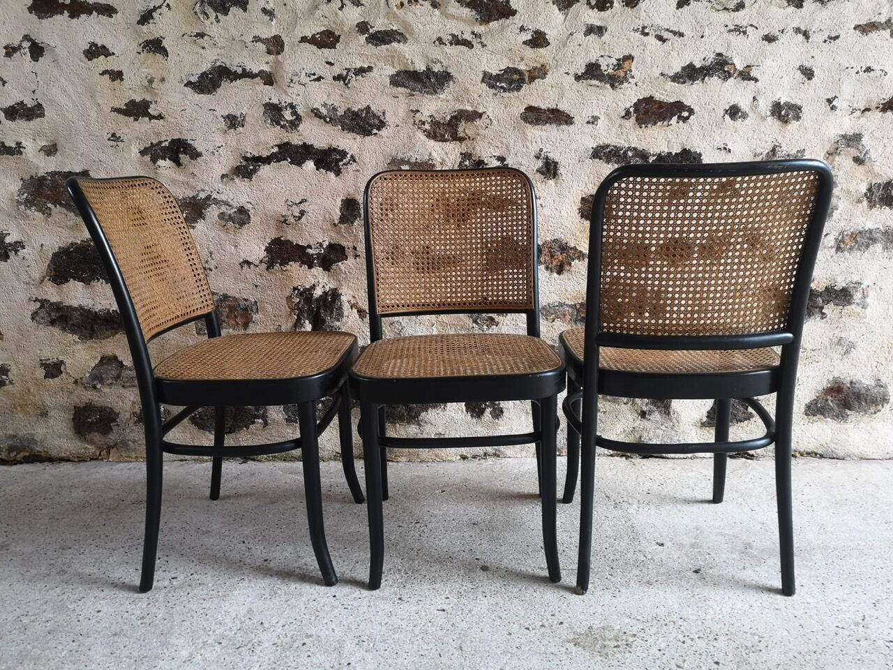 Blackened wooden chairs and cannage around 1980