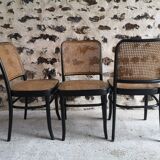 Blackened wooden chairs and cannage around 1980