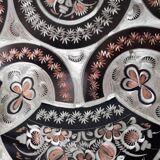 Oriental dish in chiseled red copper