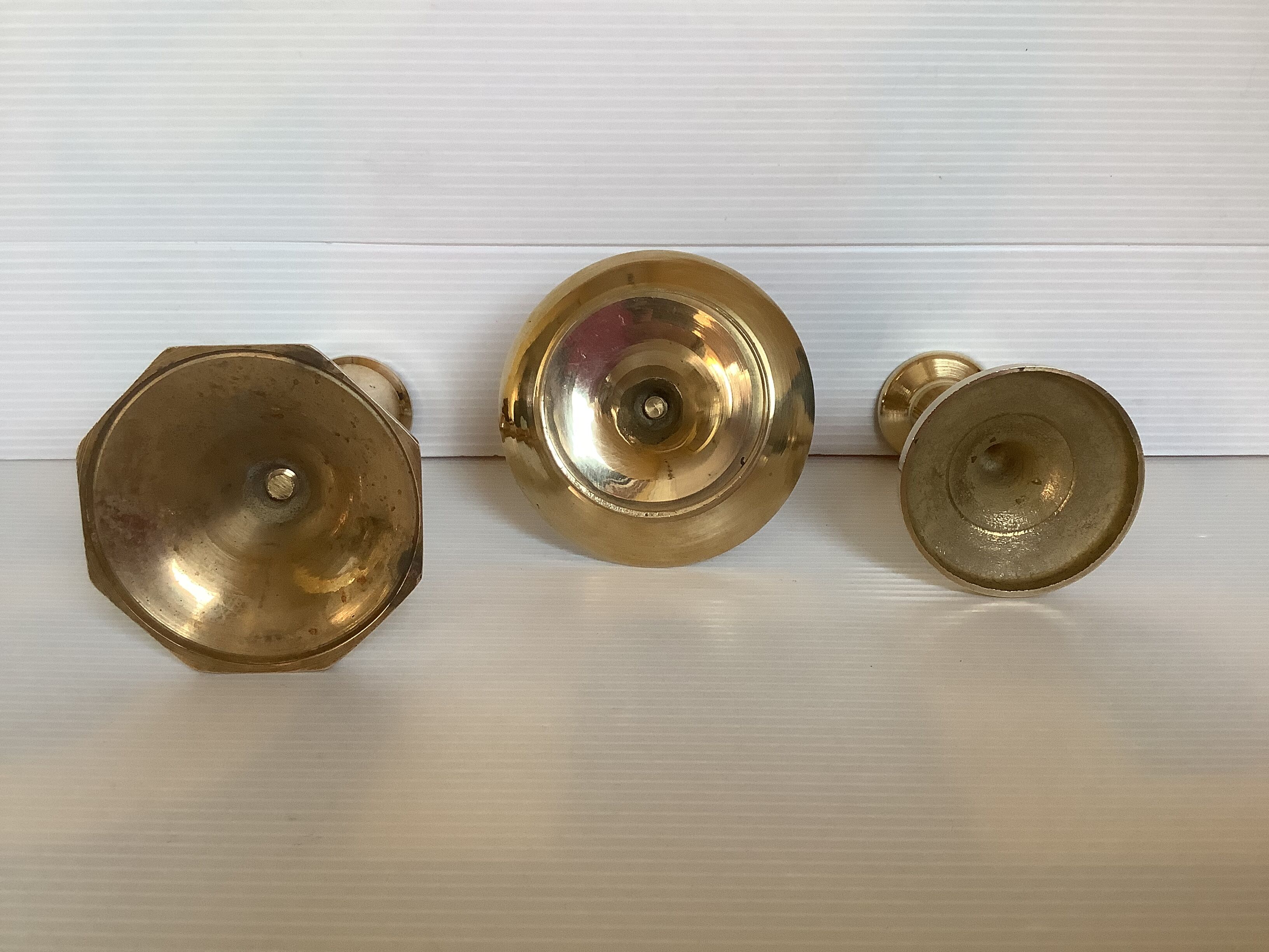 Trio of brass candle holders