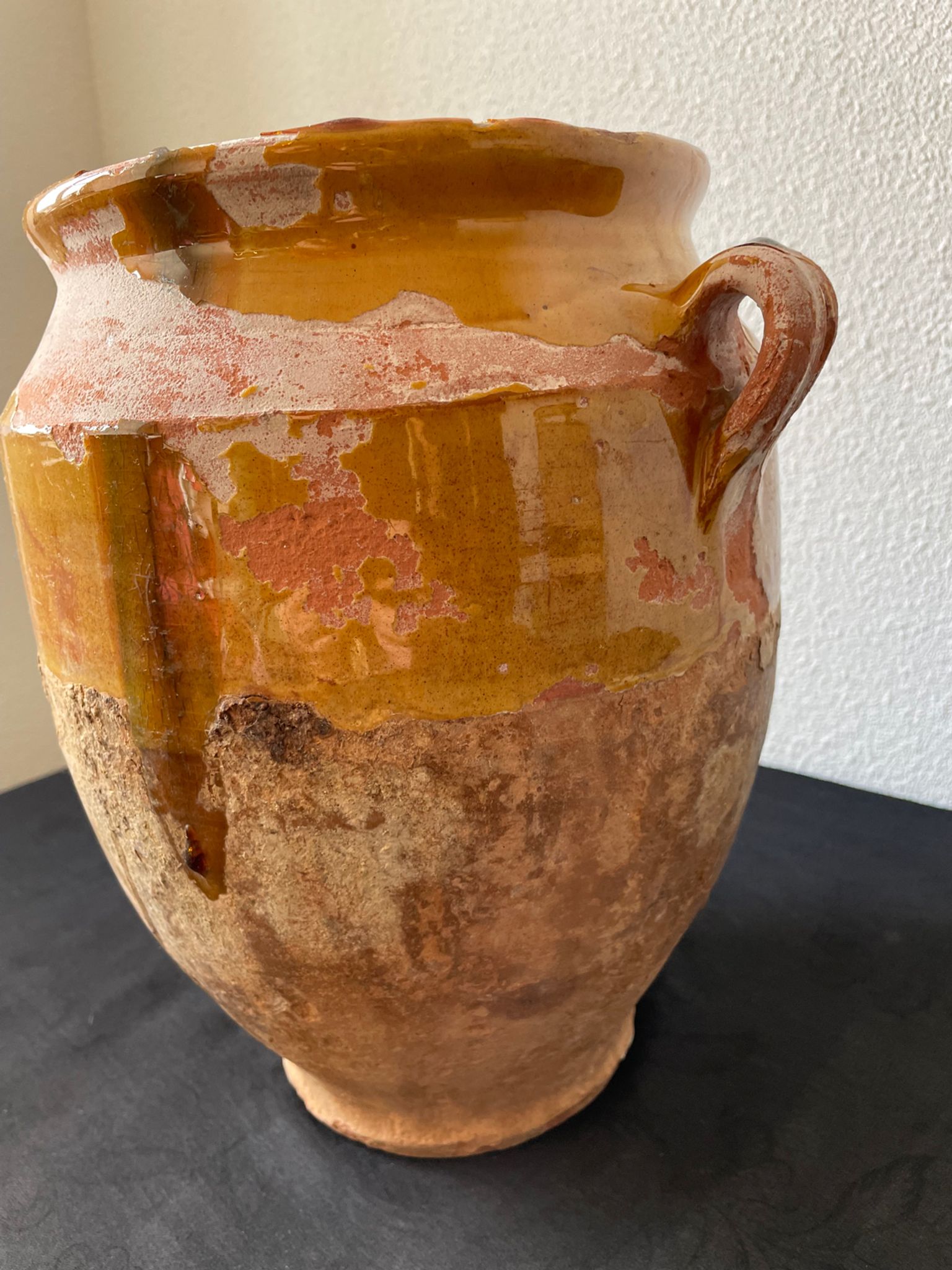 Old grease pot in glazed yellow terracotta, France nineteenth century