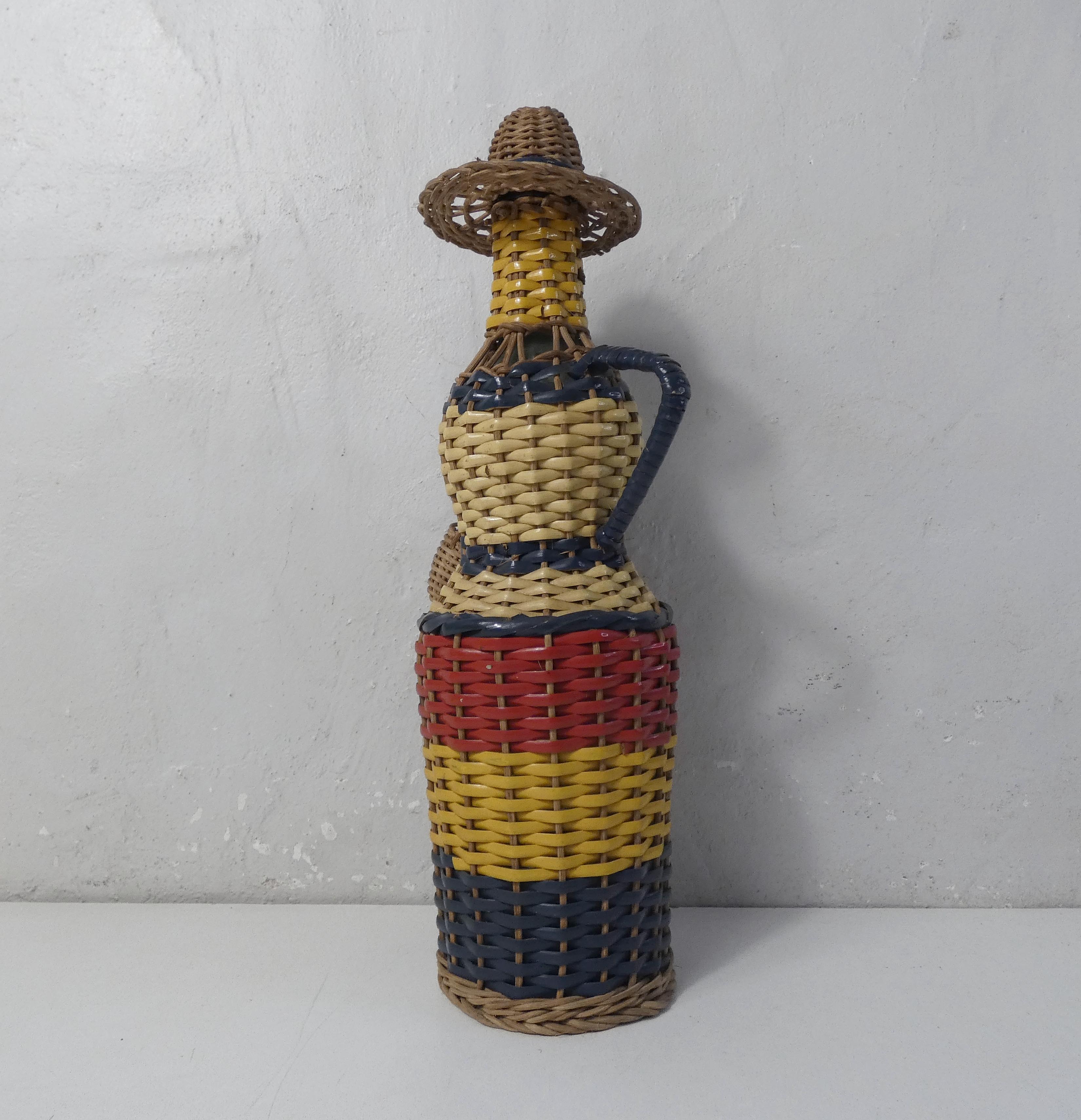 Old bottle dressed in scoubidou style rattan