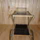 Rolling dessert in gold metal and trays in black formica