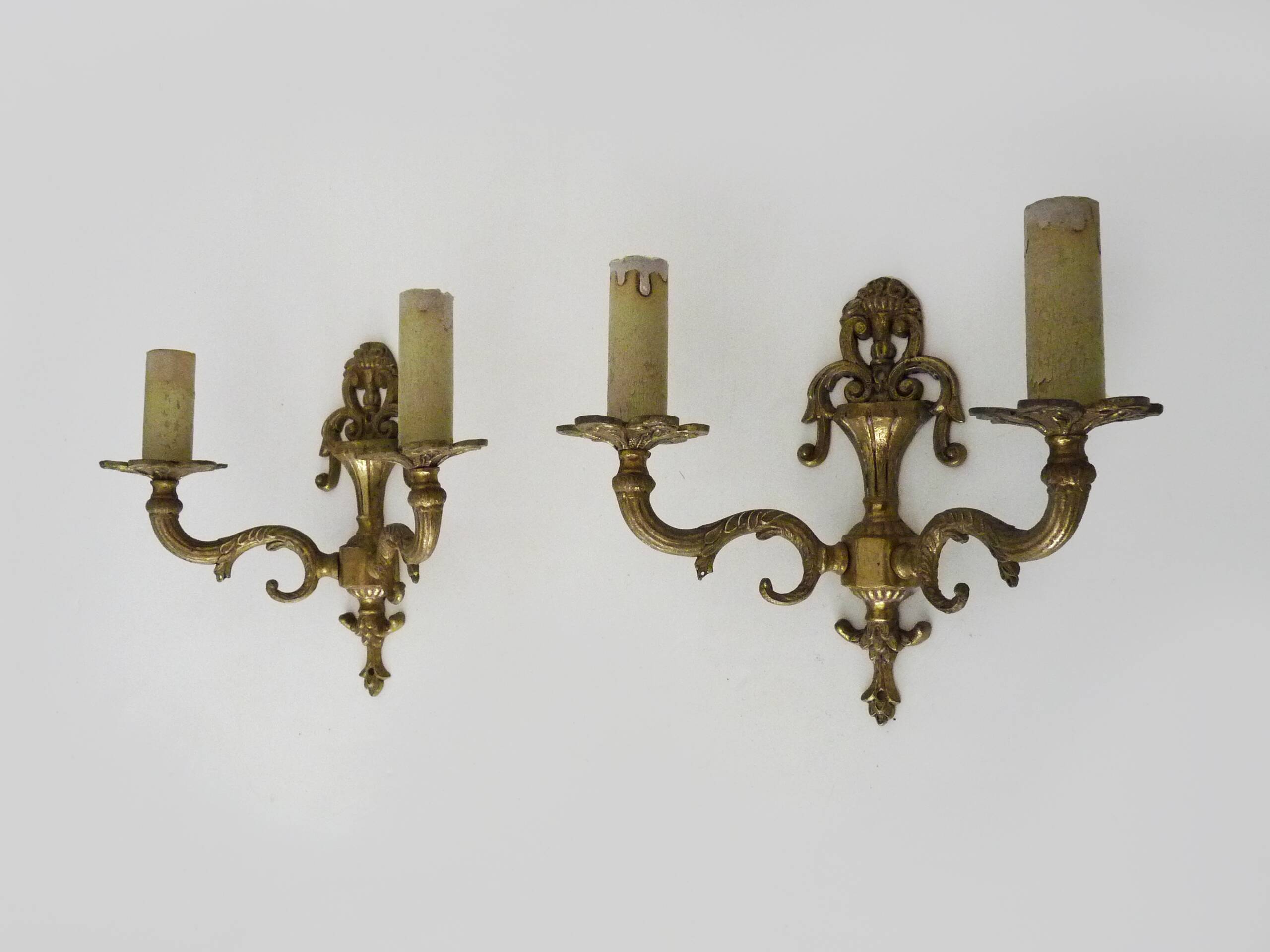 Pair of two-armed fire pot wall lights in gilded bronze.
