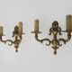 Pair of two-armed fire pot wall lights in gilded bronze.