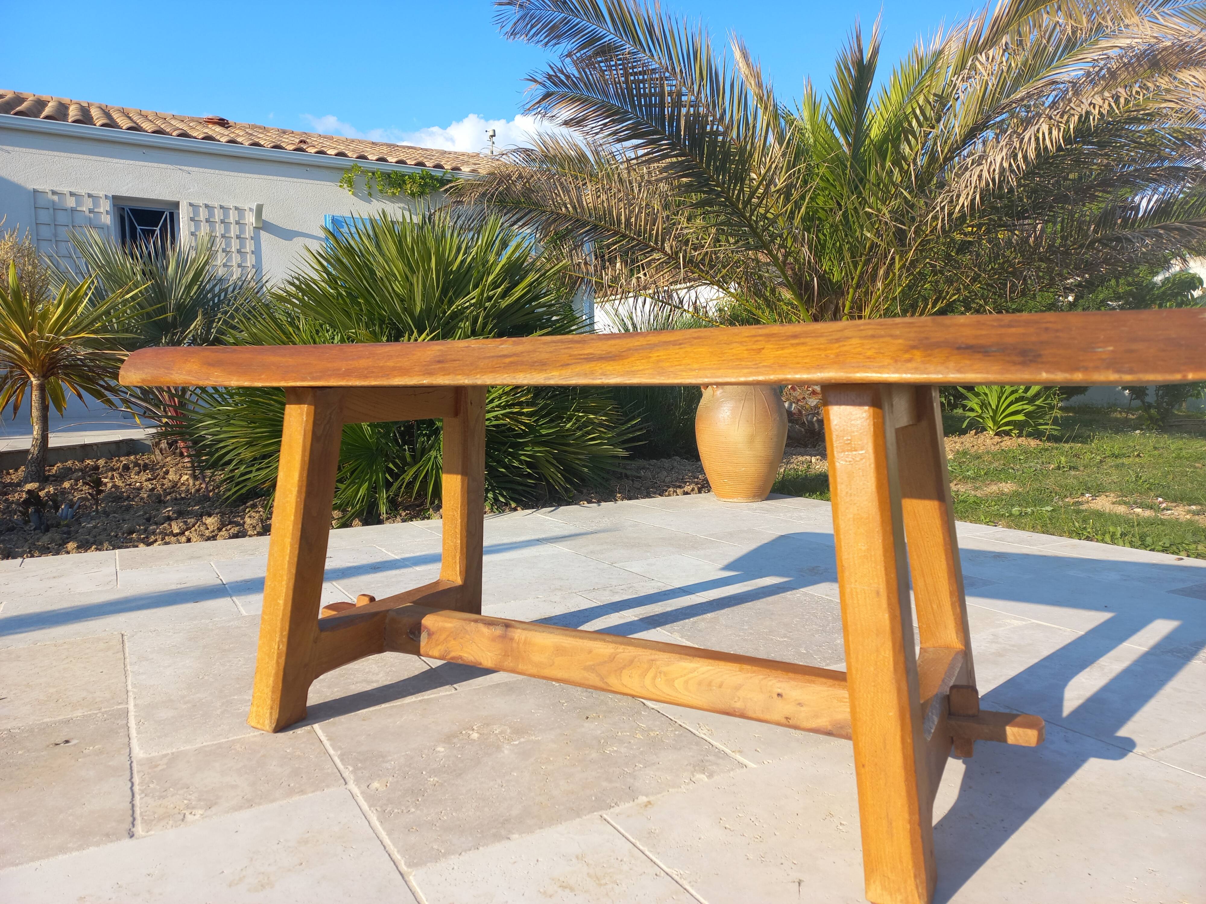 Rustic handcrafted coffee table with a mahogany top and elm legs.