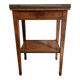 Occasional table in walnut burl and brass gallery.