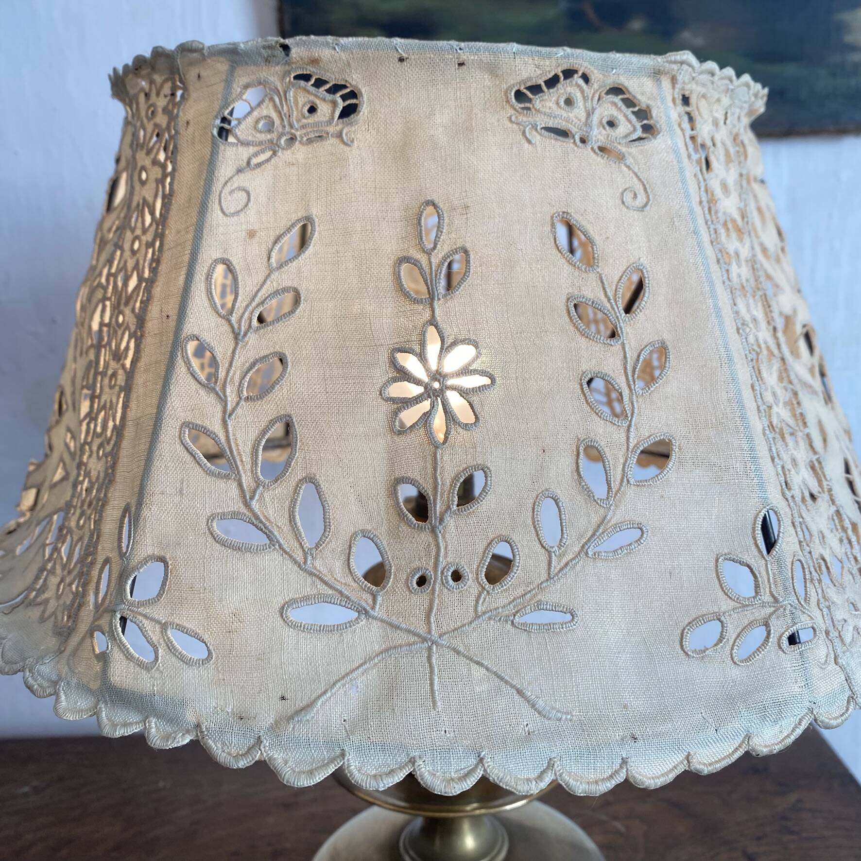 Antique brass lamp with embroidered openwork shade.