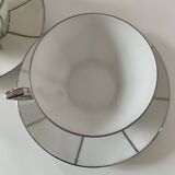 Two Art Deco porcelain cups and saucers with silver trim.