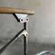 Pair of vintage silver aluminum wire folding chairs with wooden armrests — industrial minimalist