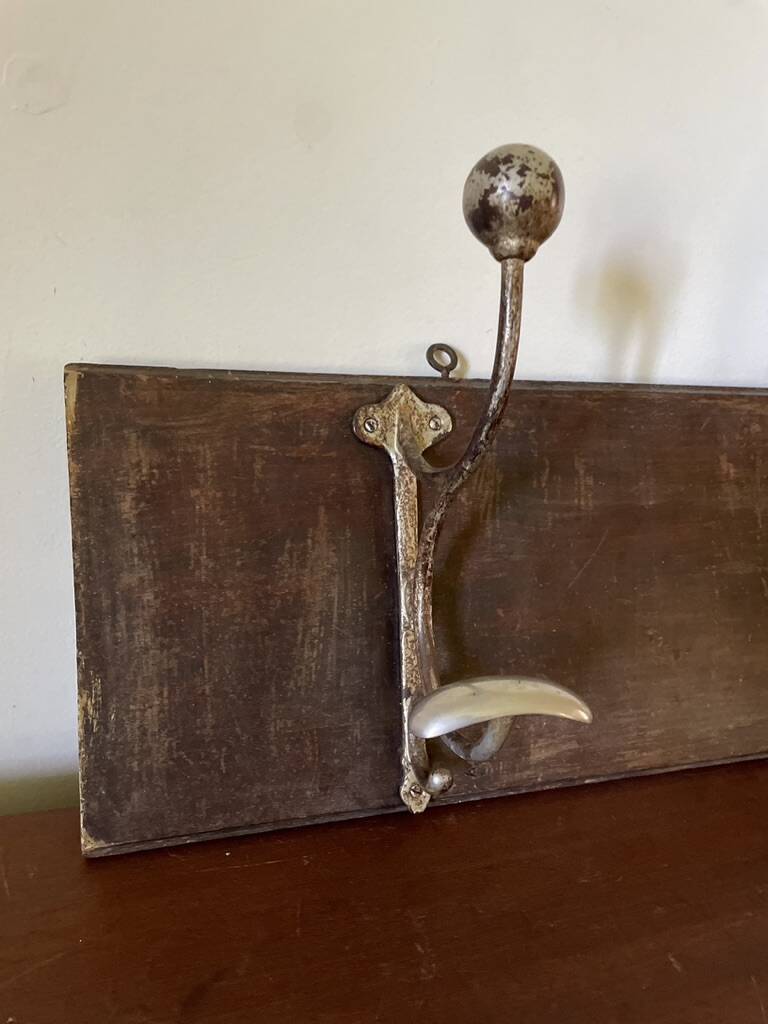 Patinated wood and metal coat rack from the 1950s.