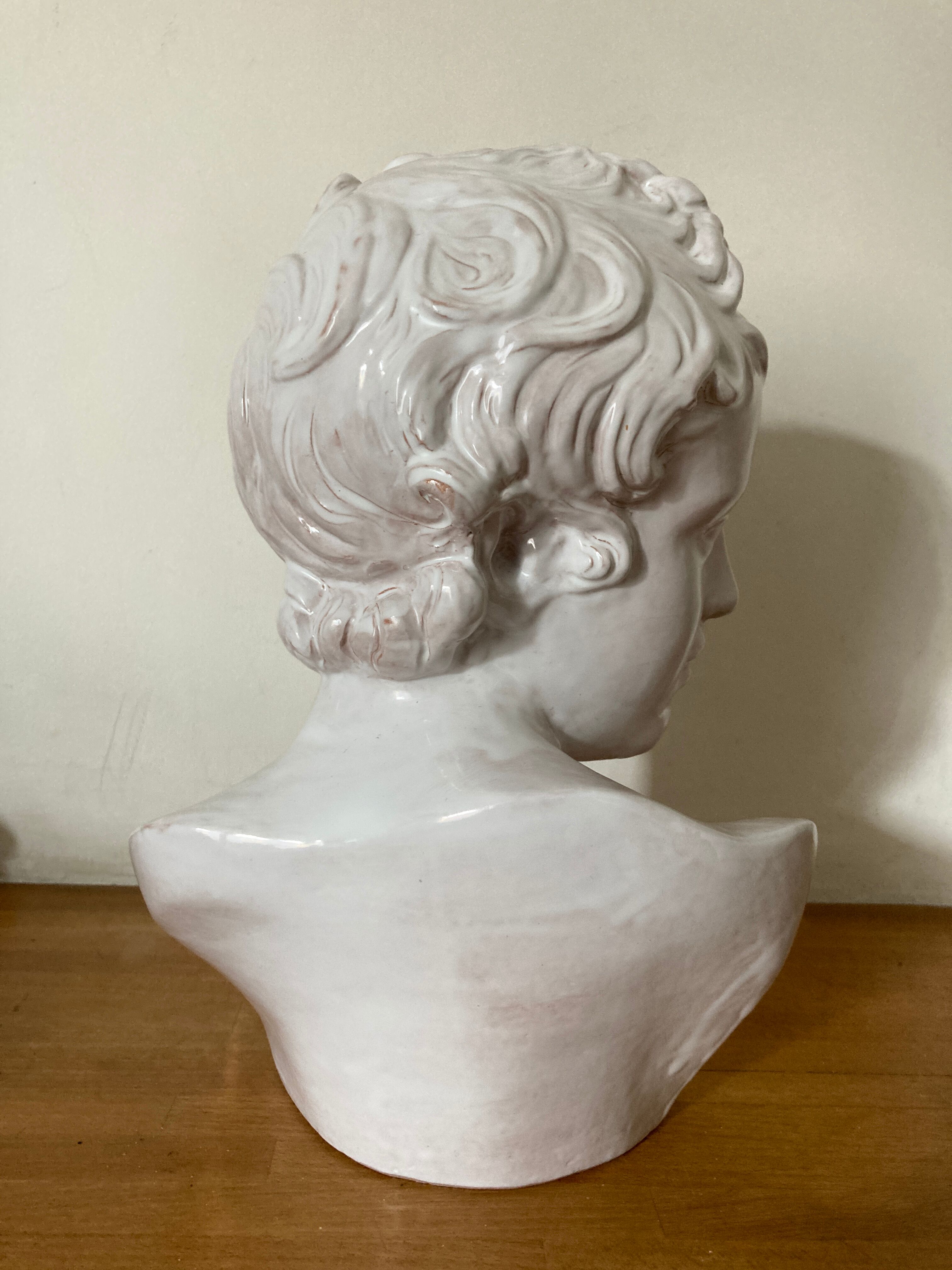 White enamelled terracotta Eros bust