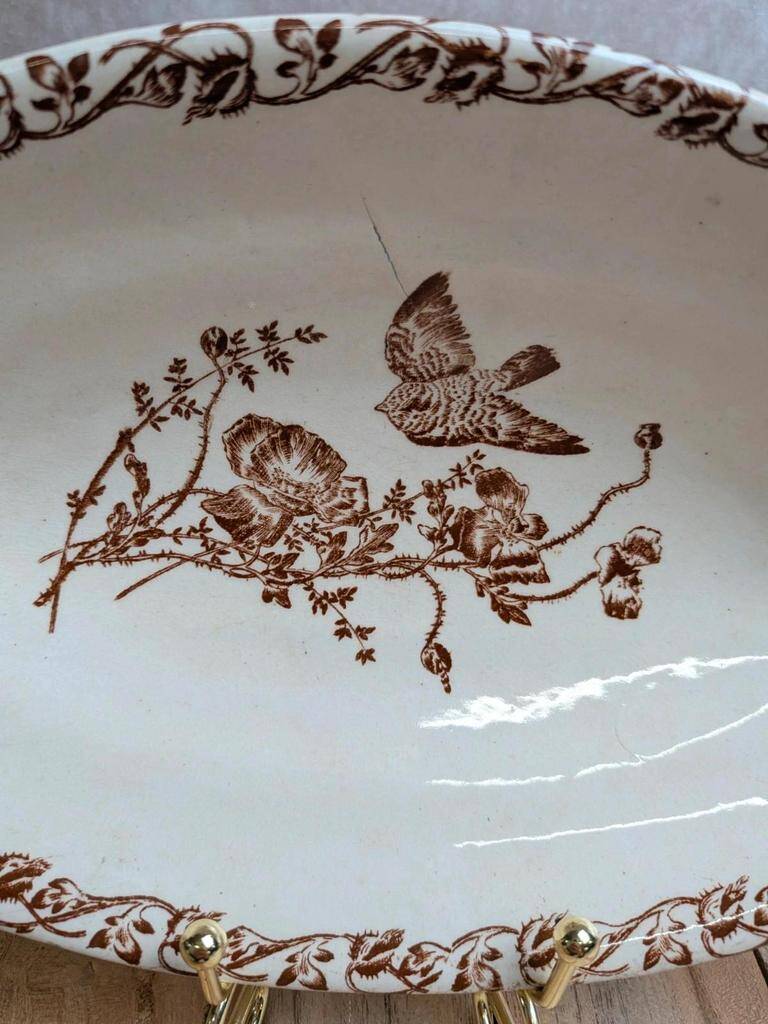 Old Ravier in ironstone decorated with birds and poppies.