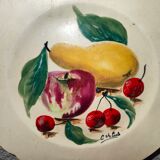 Faience plate in Longwy enamels signed Léa Valenti representing Fruits