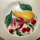 Faience plate in Longwy enamels signed Léa Valenti representing Fruits