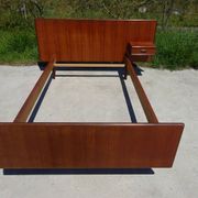 Vintage bed in teak with integrated bedside table.