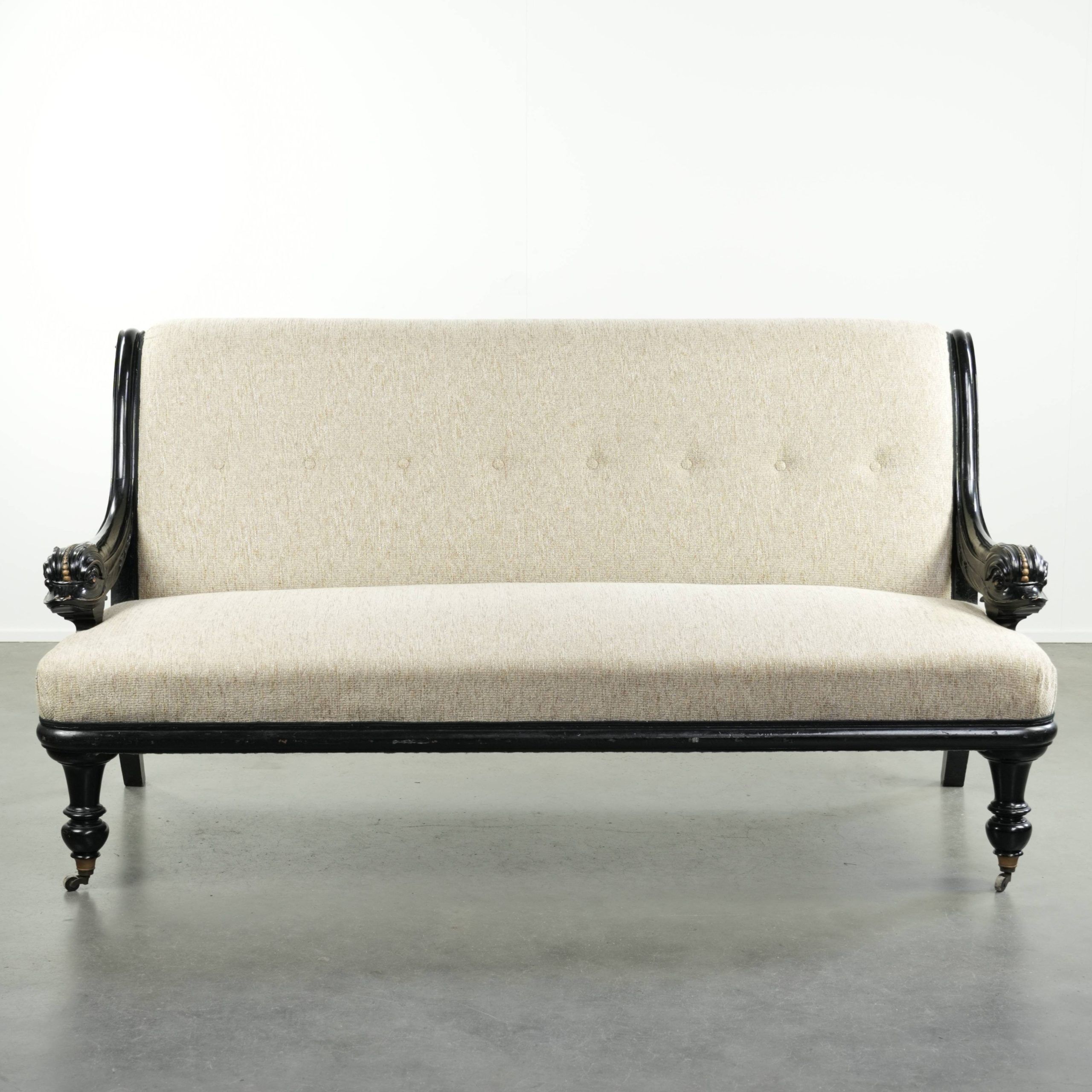 French sofa from the 19th century in Empire style with detailed armrests