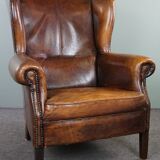Dark wingback armchair made of sheep leather with stunning colors