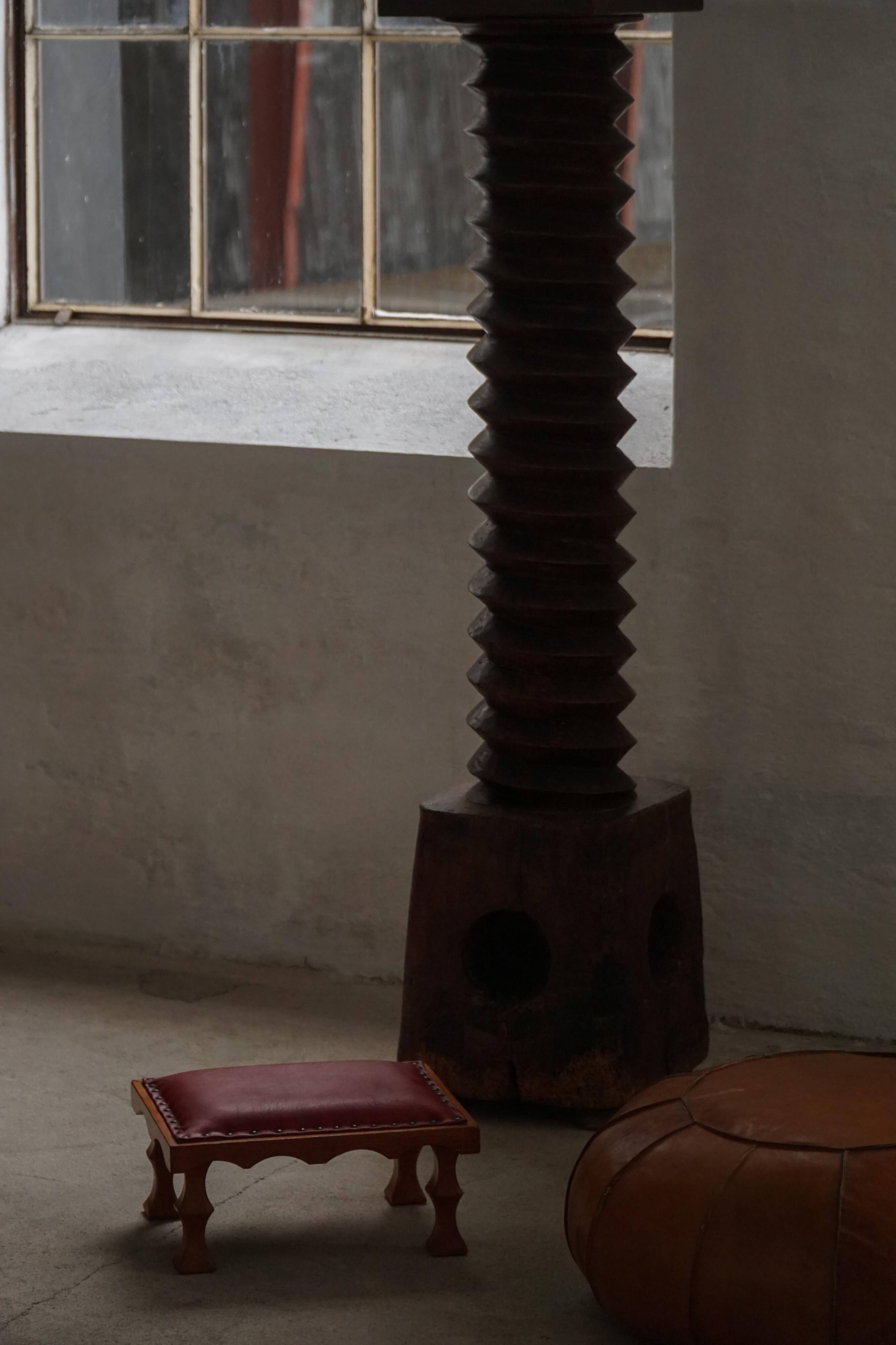 Danish sculpted oak stool from the mid-20th century with a red leather seat, 1950s.