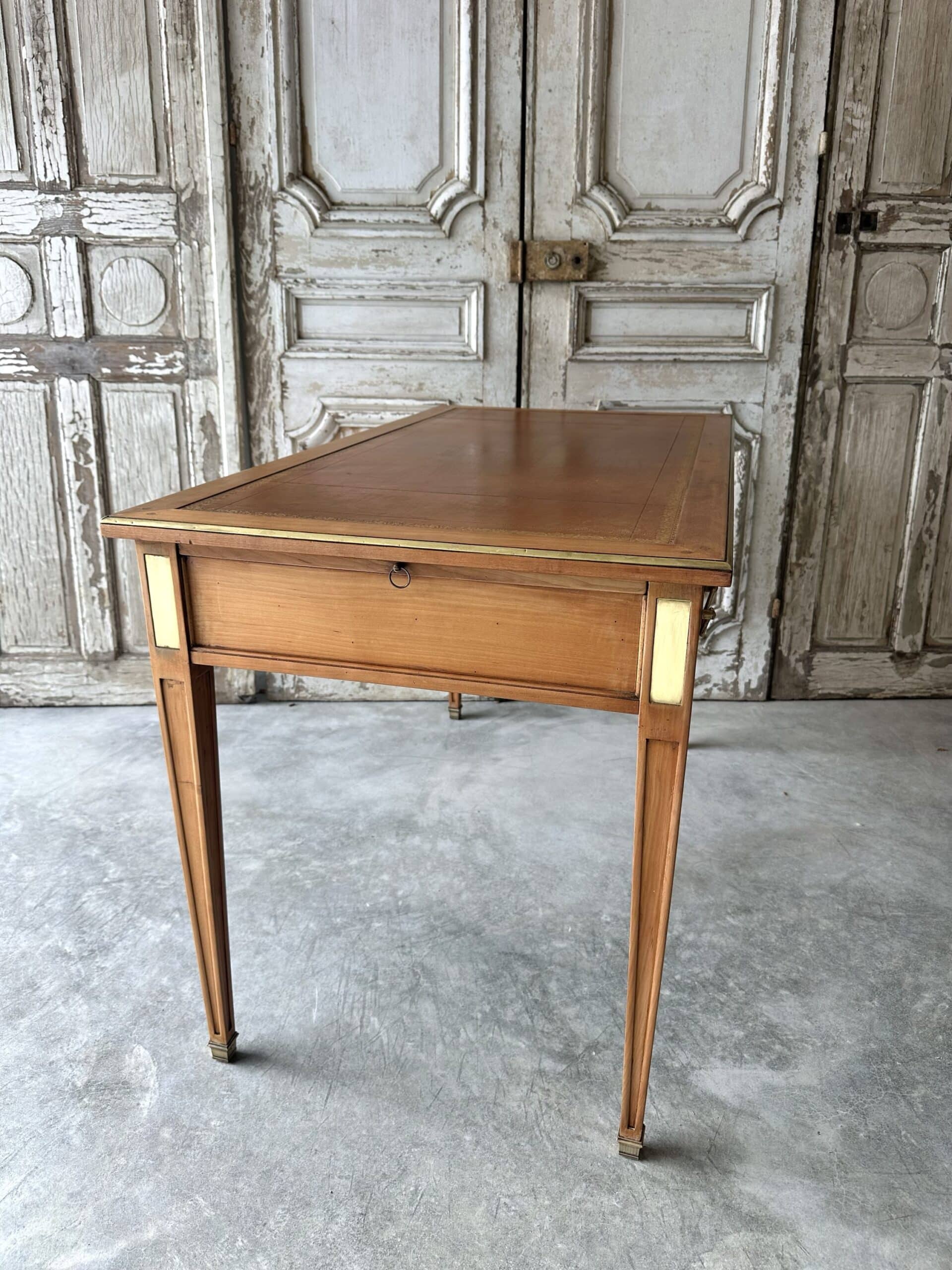 Directoire style flat desk circa 1960 in light cherry wood.