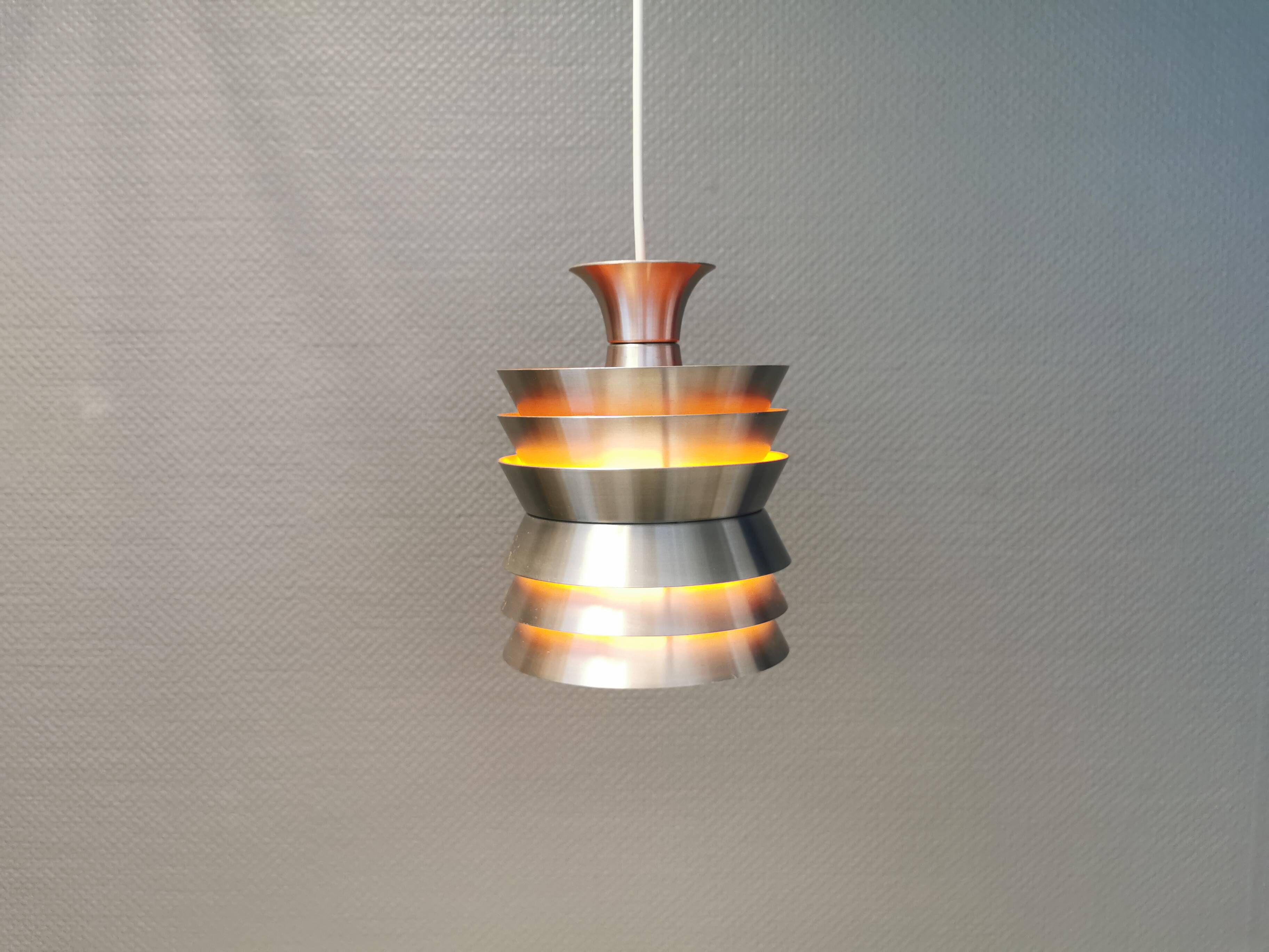 Danish/Swedish hanging lamp, in silver-coloured aluminium with orange interior paint.