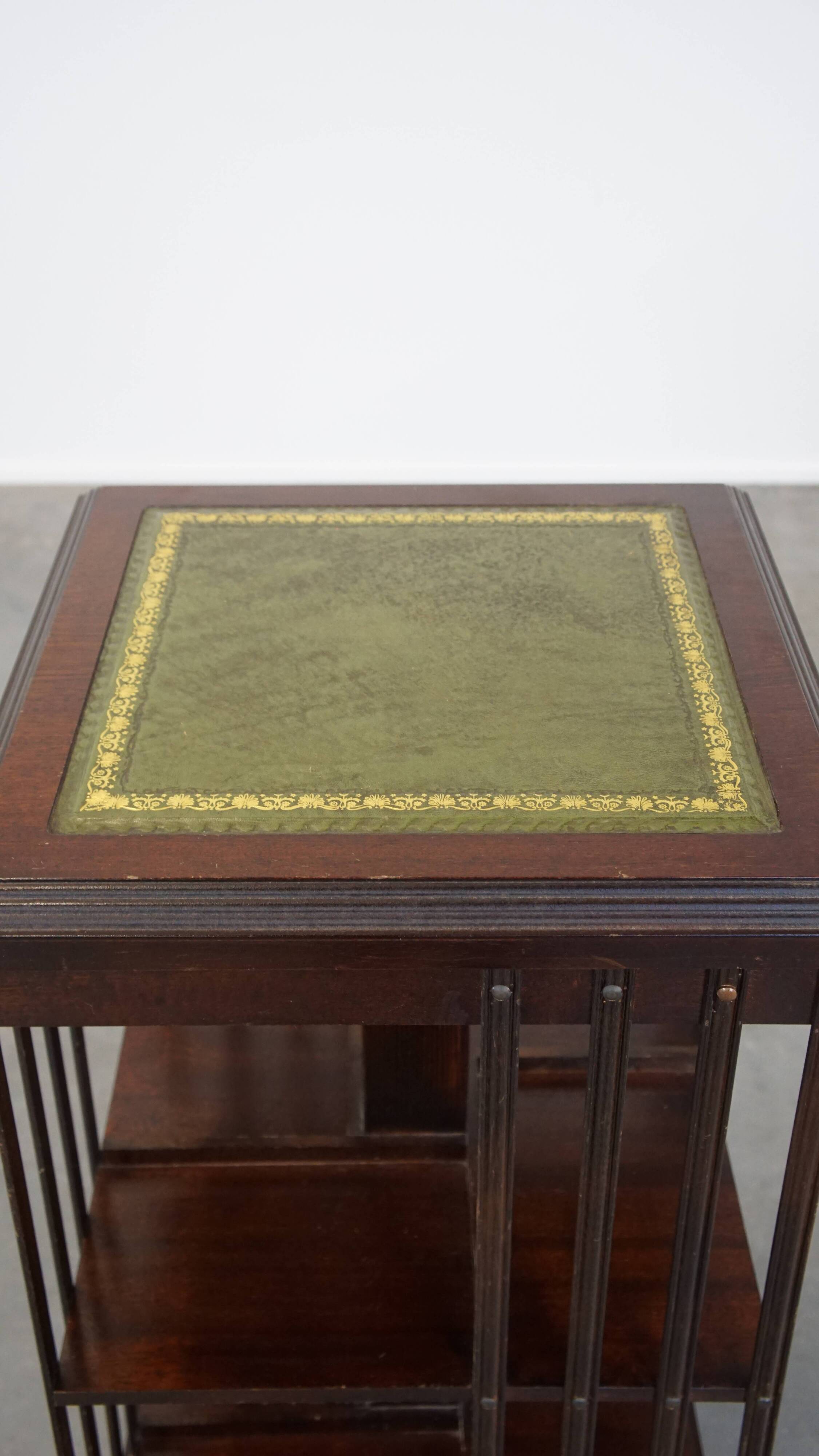 Wooden bookstand with green leather surface and on wheels in English style