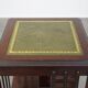 Wooden bookstand with green leather surface and on wheels in English style