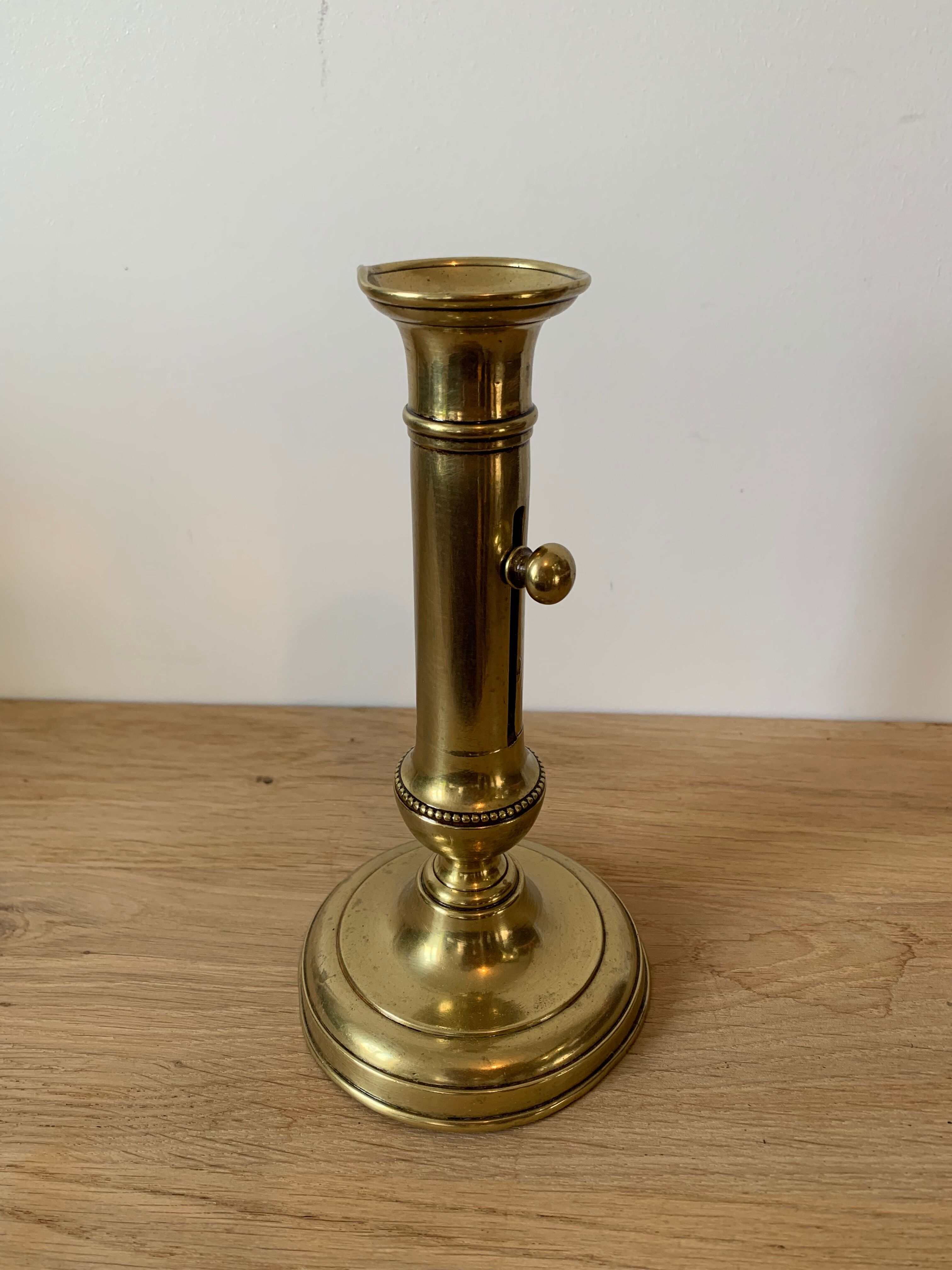 Brass pusher candle holder