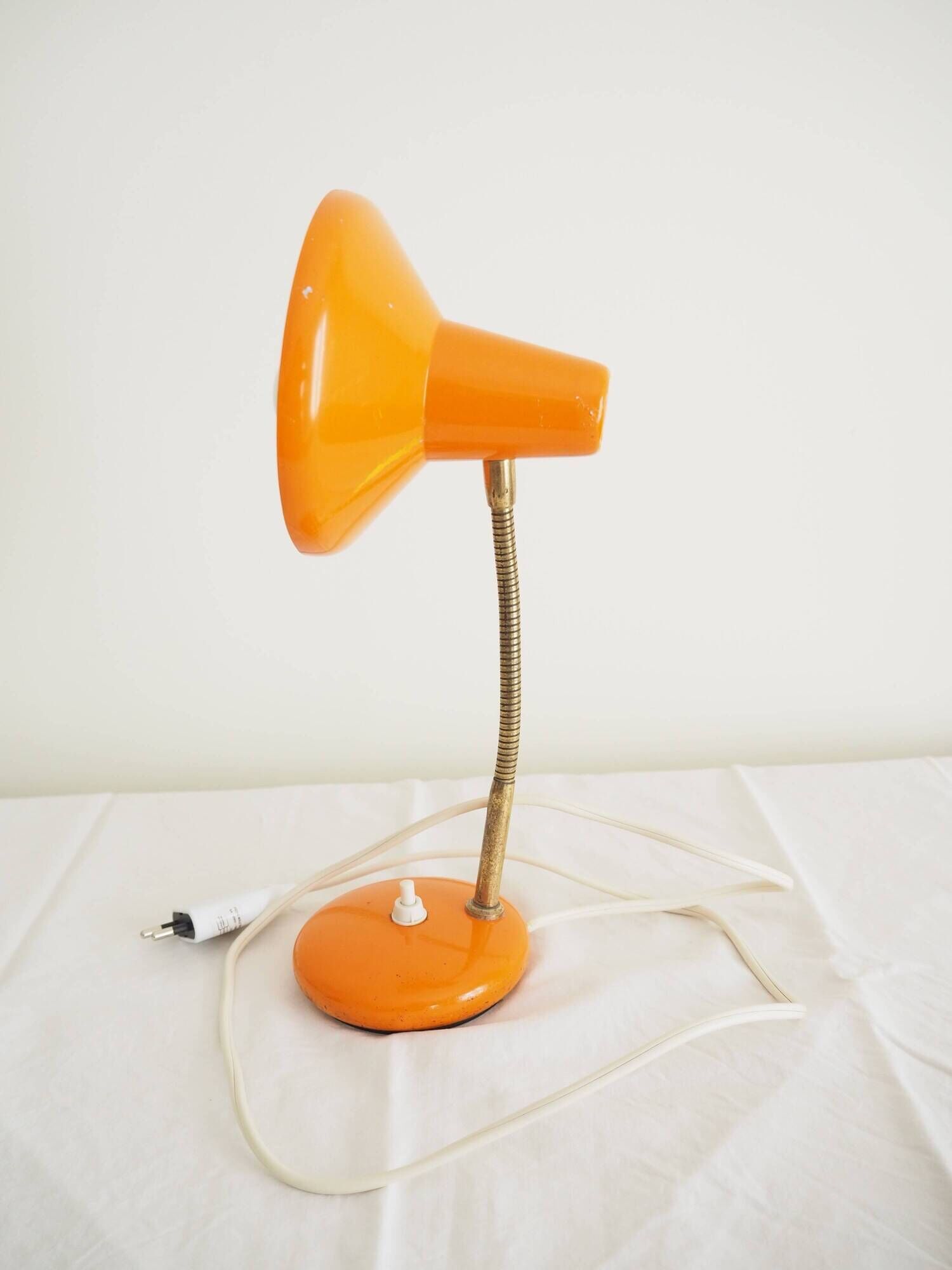 Orange colored metal desk lamp from the 1960s-1970s