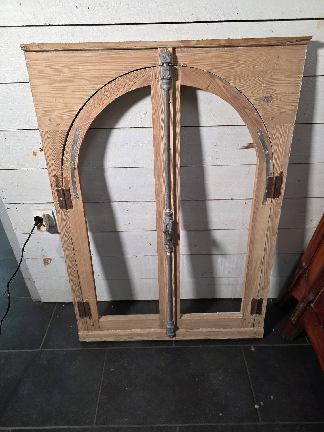 Old arched window made of fir wood