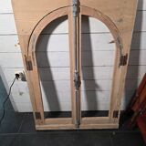 Old arched window made of fir wood