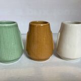 Set of three small Moai-style head vases.