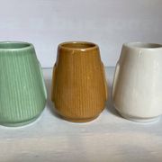 Set of three small Moai-style head vases.