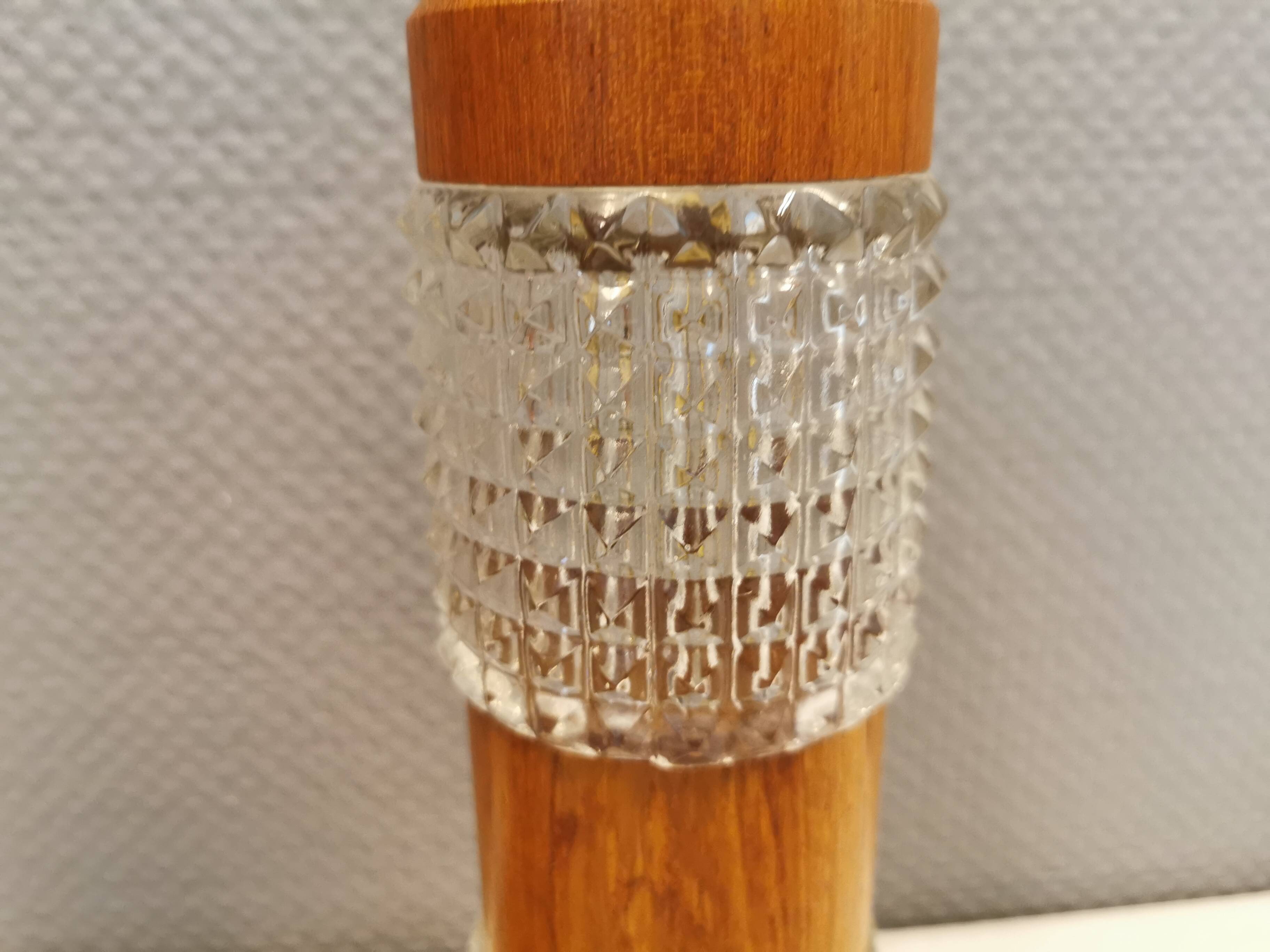 Swedish table lamps made of teak wood and hard pressed crystal glass.