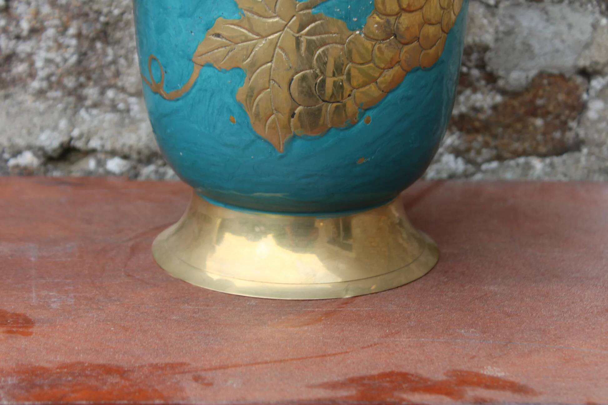 Vintage turquoise brass champagne bucket with grape decoration.