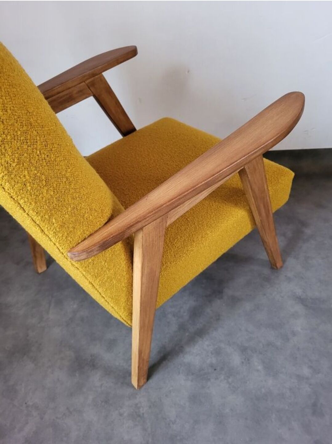 Curly yellow Scandinavian armchair