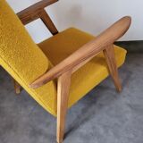 Curly yellow Scandinavian armchair