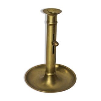 Candle holder with a brass pusher
