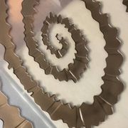 Round coffee table with double glass top, spiral carved decoration.
