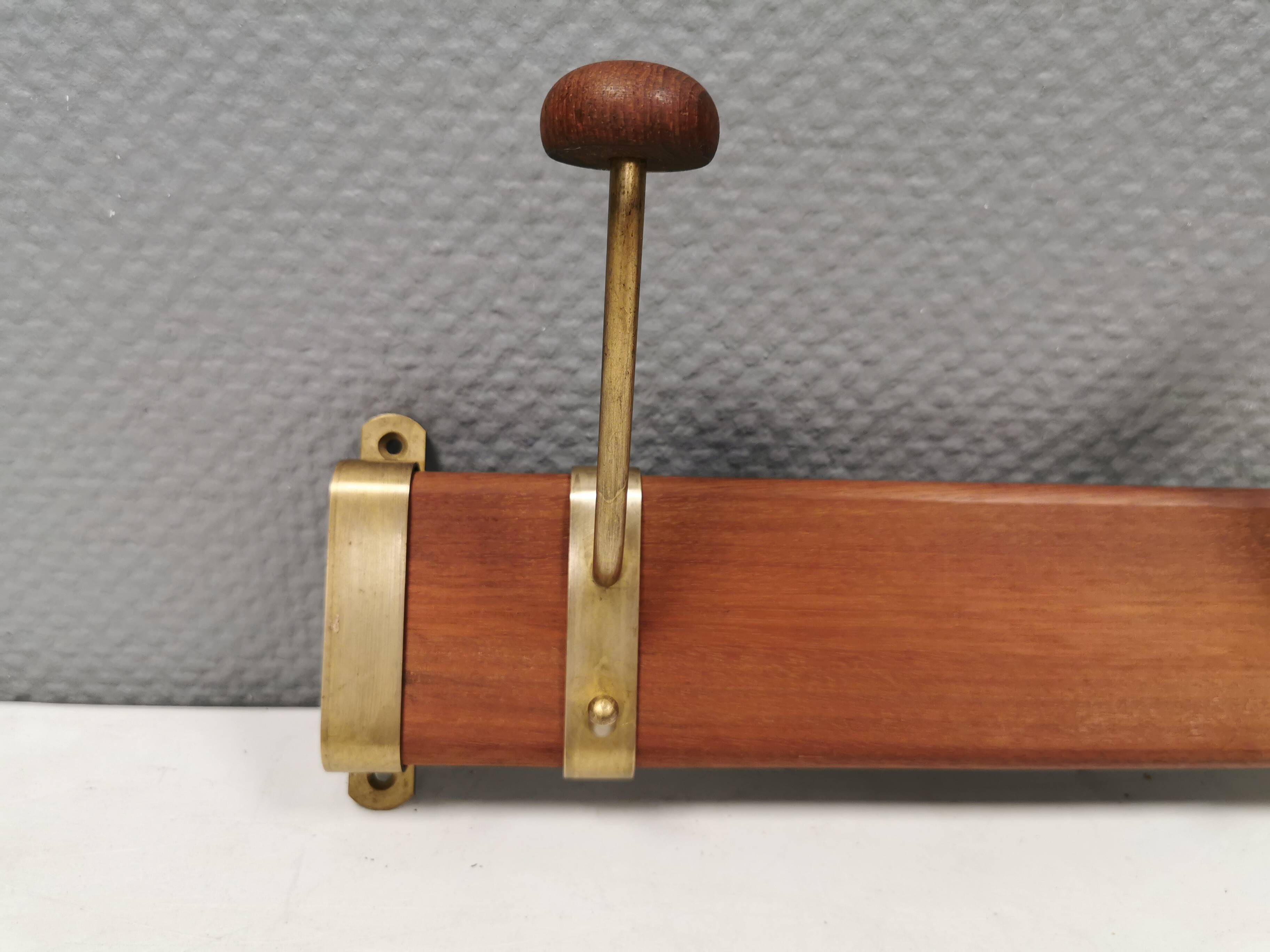 Danish teak and brass coat rack with adjustable hooks, 1960s.
