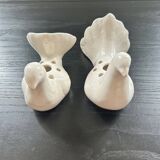 Duo of doves pecking flowers