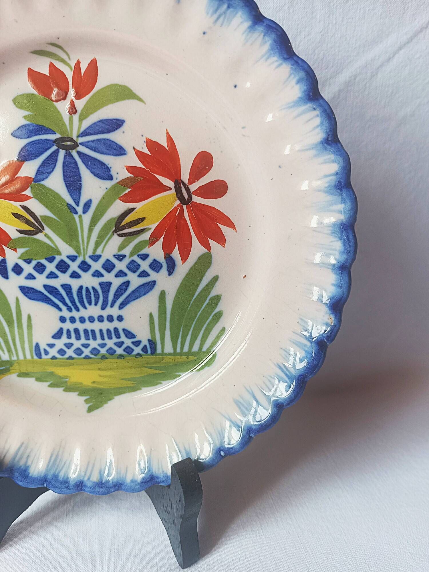 Pair of antique plates in popular earthenware with a floral basket decoration on the edge.