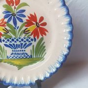 Pair of antique plates in popular earthenware with a floral basket decoration on the edge.