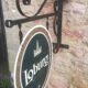 Double-sided "Loburg Beer" metal sign on wrought iron bracket