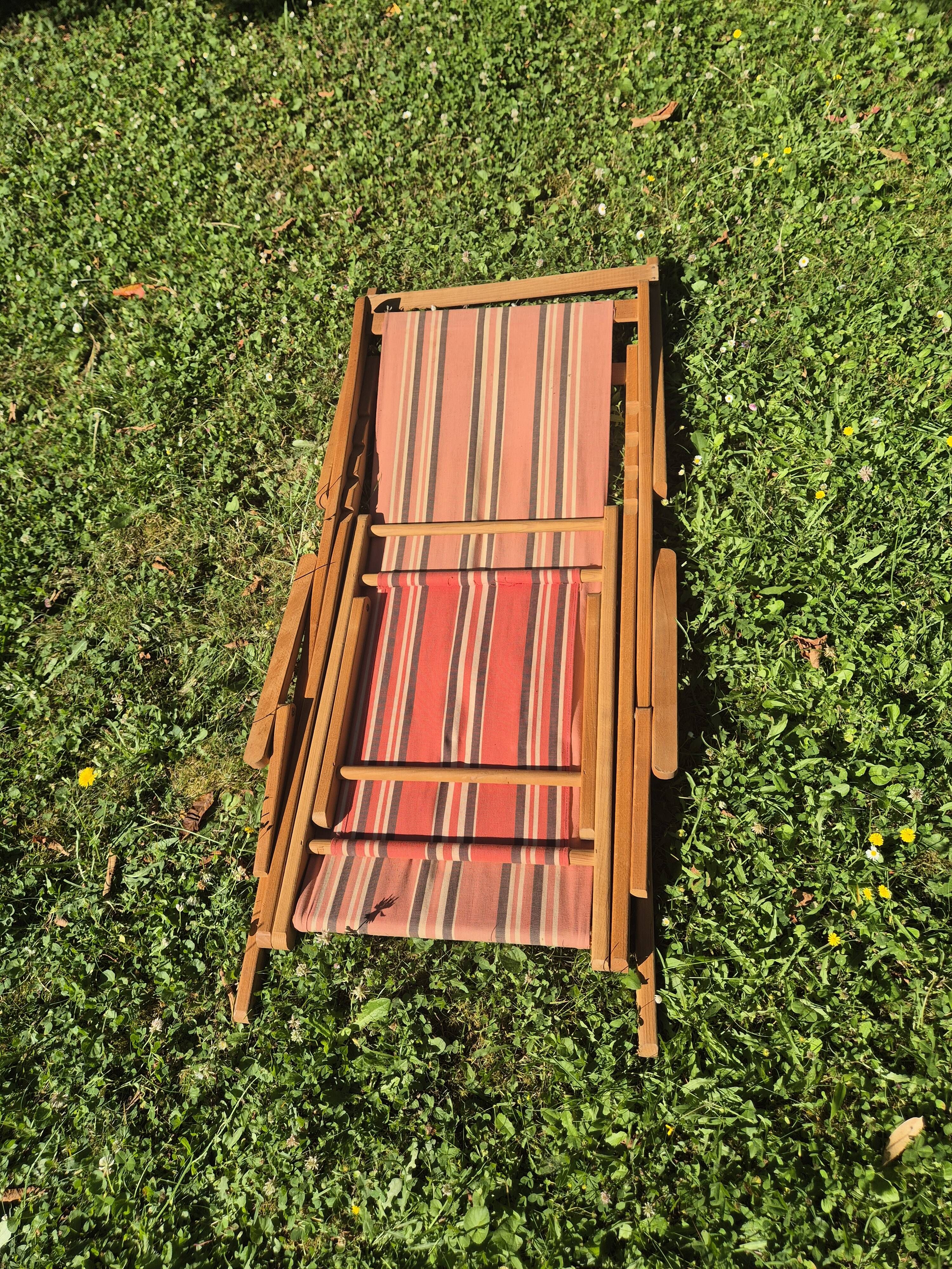 vintage wooden deck chair with striped fabric and footrest
