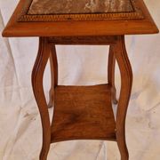 Antique Art Nouveau pedestal table with carved wood and marble top.