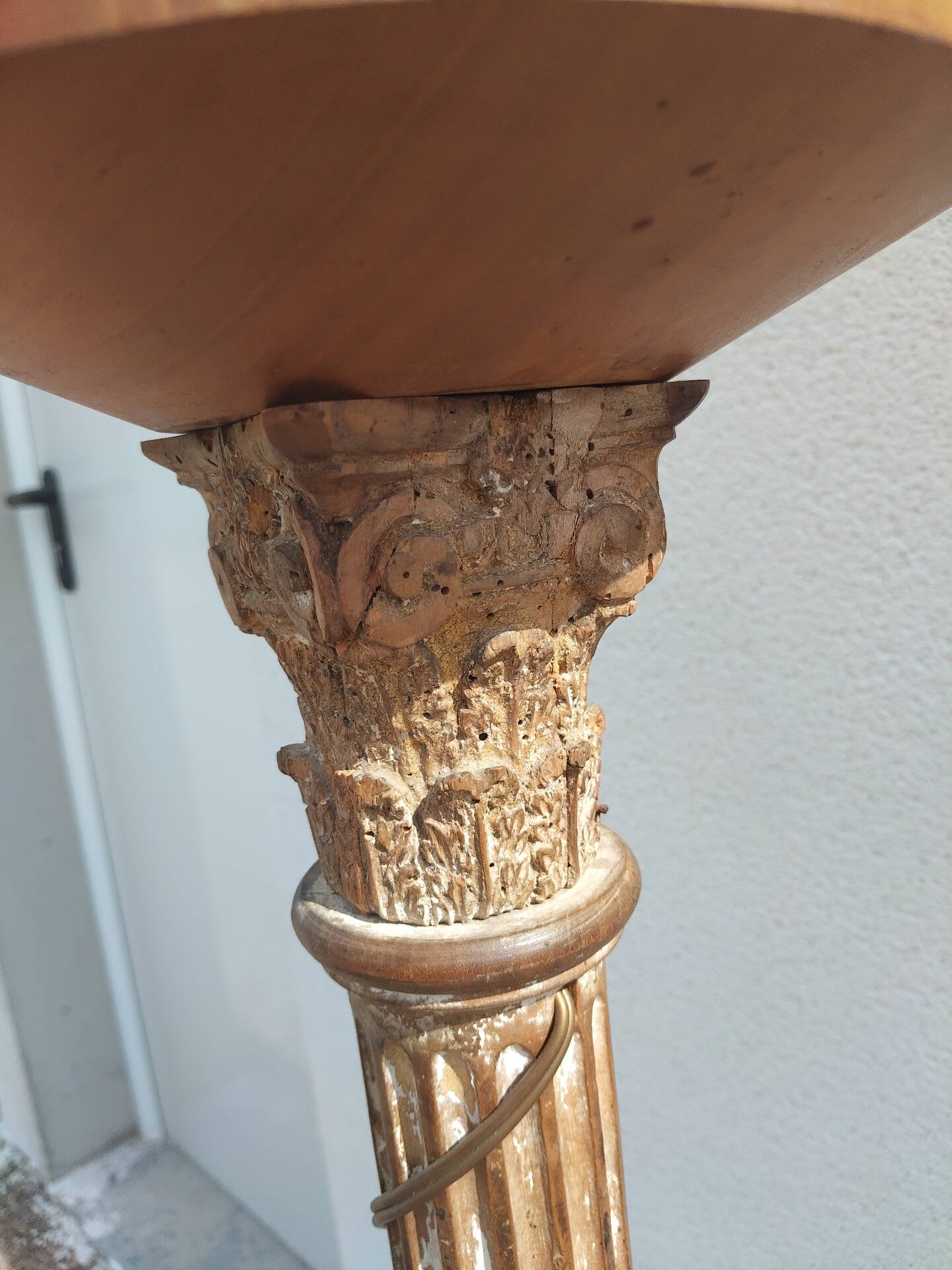 Large antique church candlestick in carved wood transformed into a lamp.