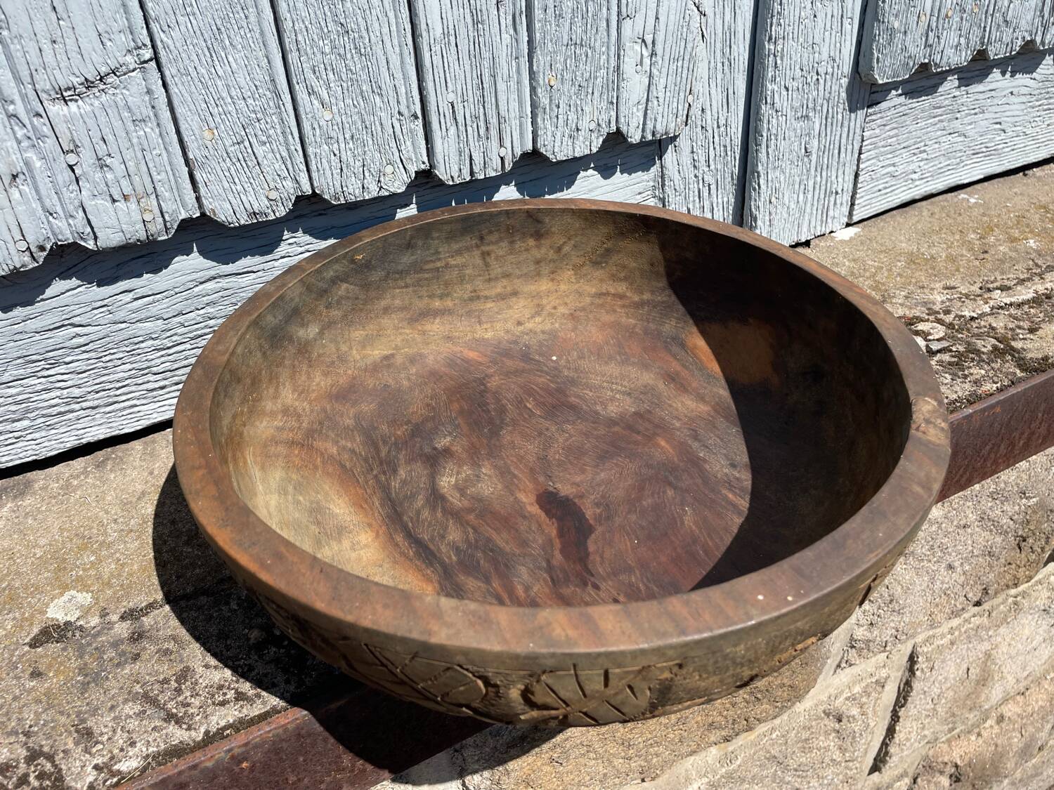 Old carved wooden bowl with African decoration.