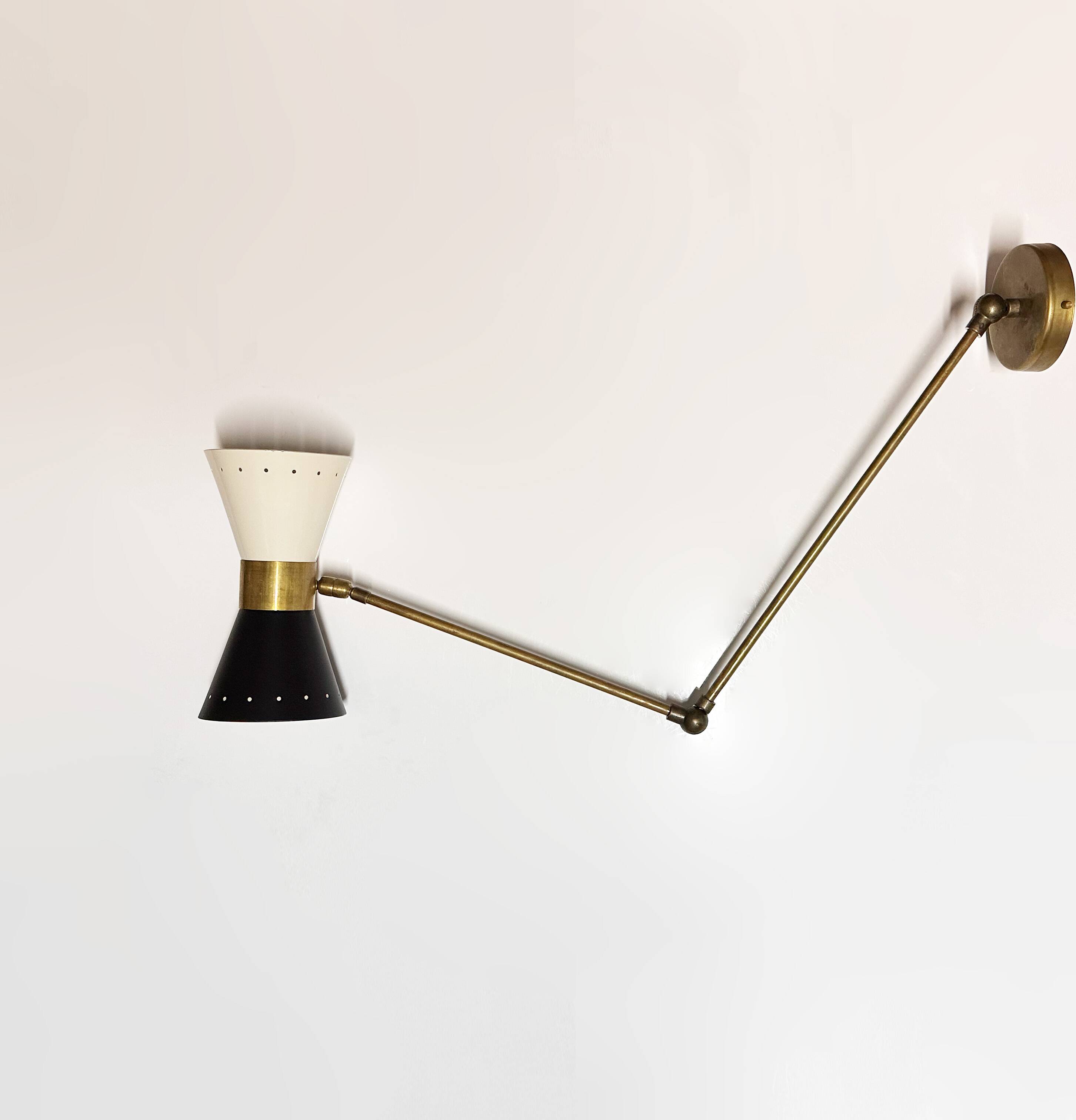 Articulated brass and lacquered iron wall light, 1950s design.